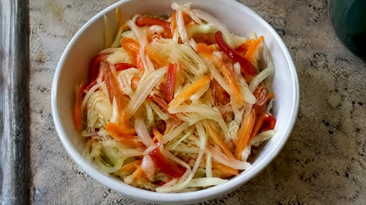 Fresh shredded pikliz with crisp cabbage strands