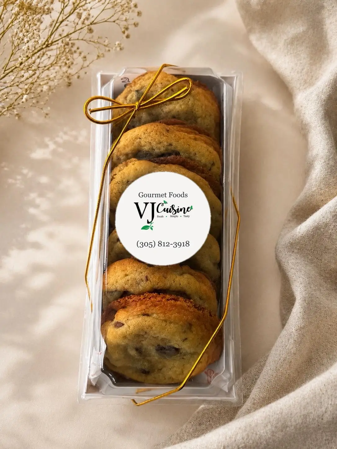 Cookie gift box tied with gold ribbon and VJ Cuisine label